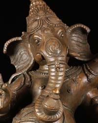 Ganesh murti trunk hanging in the center and curled to the left