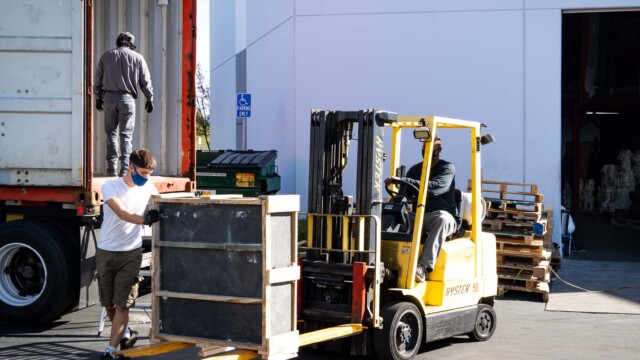 Mark and Luca unloading a large fountain basin.